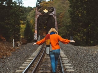 woman train tracks red sweater scarf fall