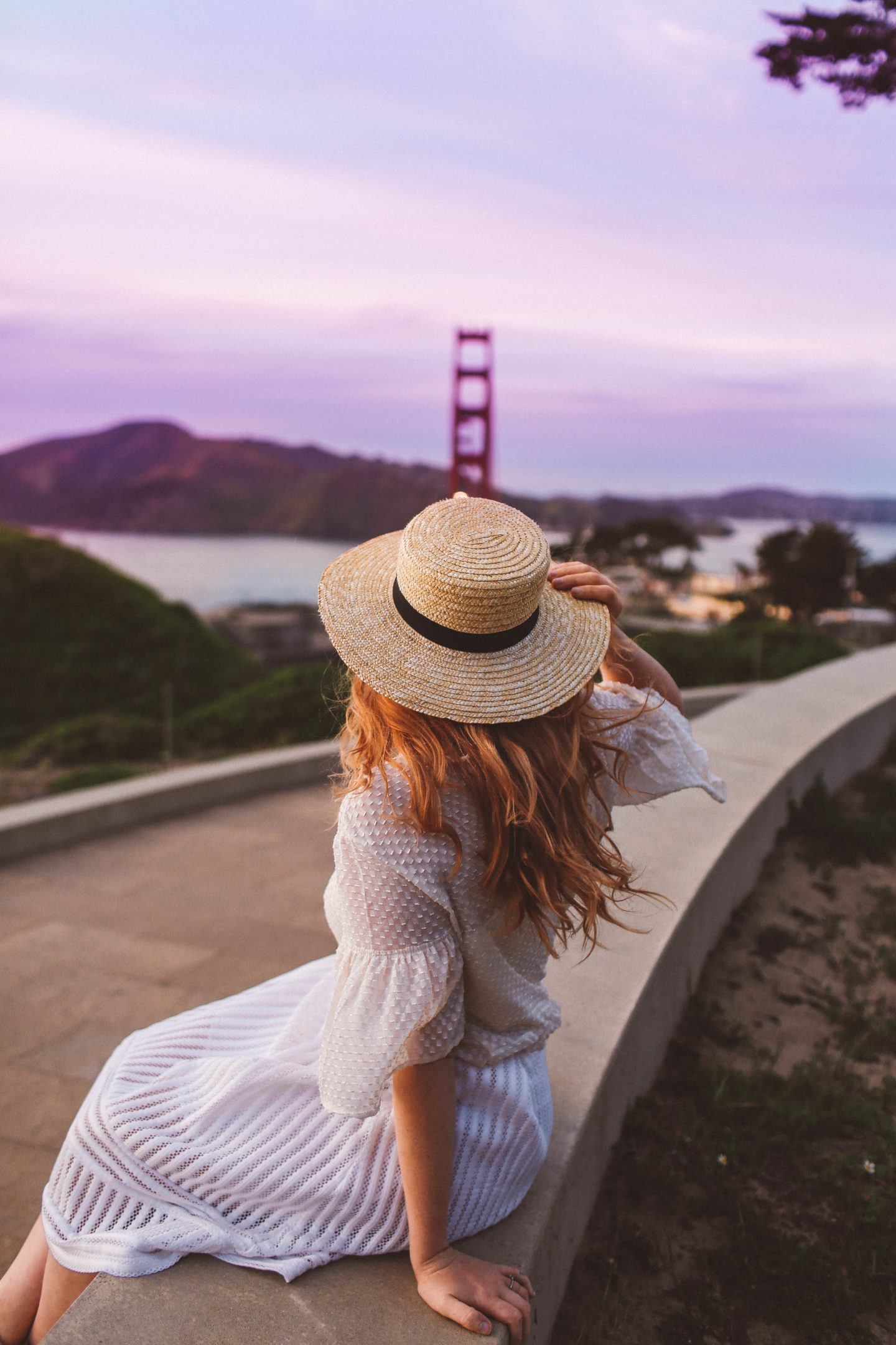Woman sitting looking at golden gate bridge from afar