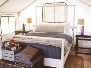 Bed and side tables in tent