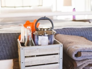 wooden crate with ammenities and towels sitting on wooden chest in tent