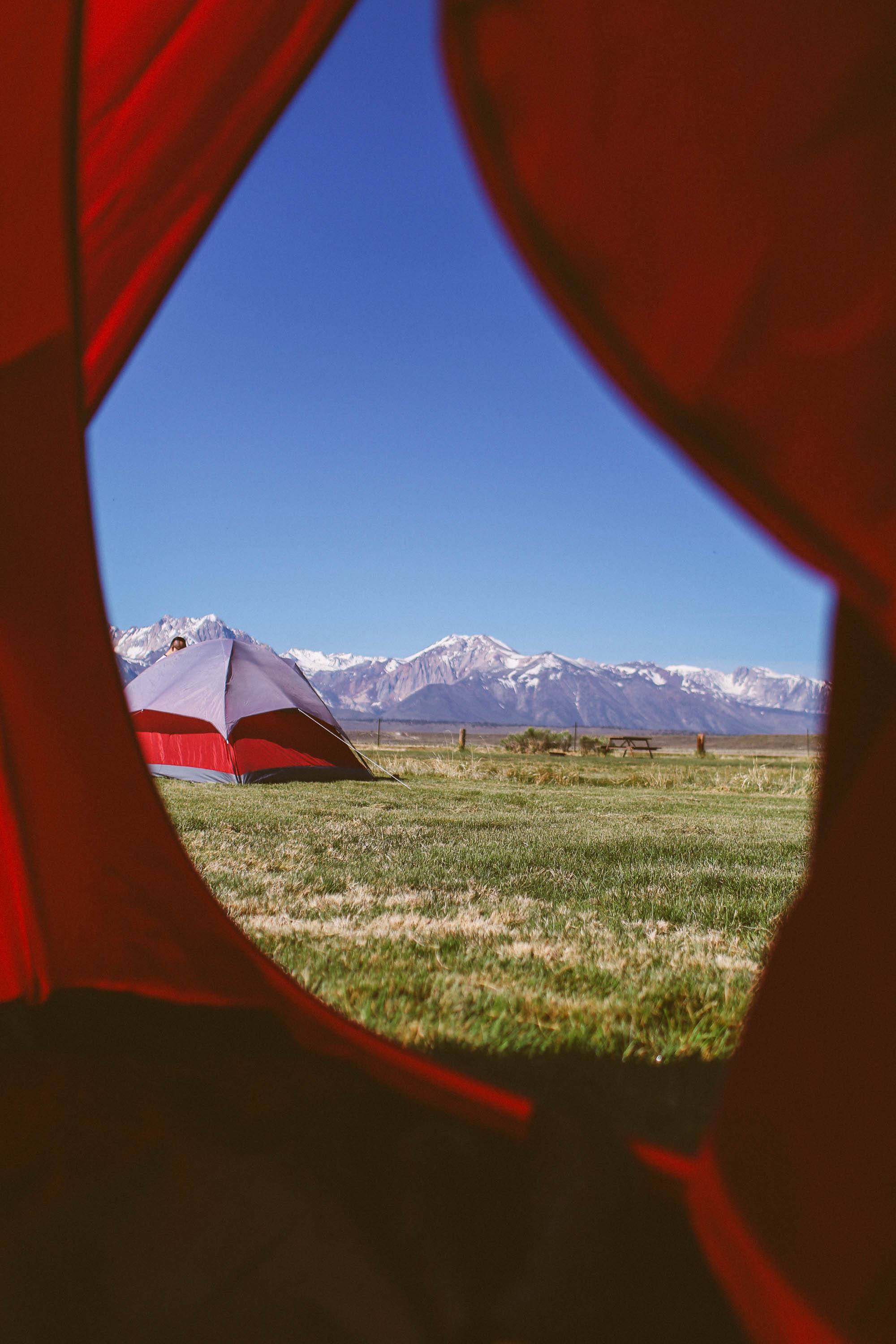 photo of a tent and the mountains from inside of a tent