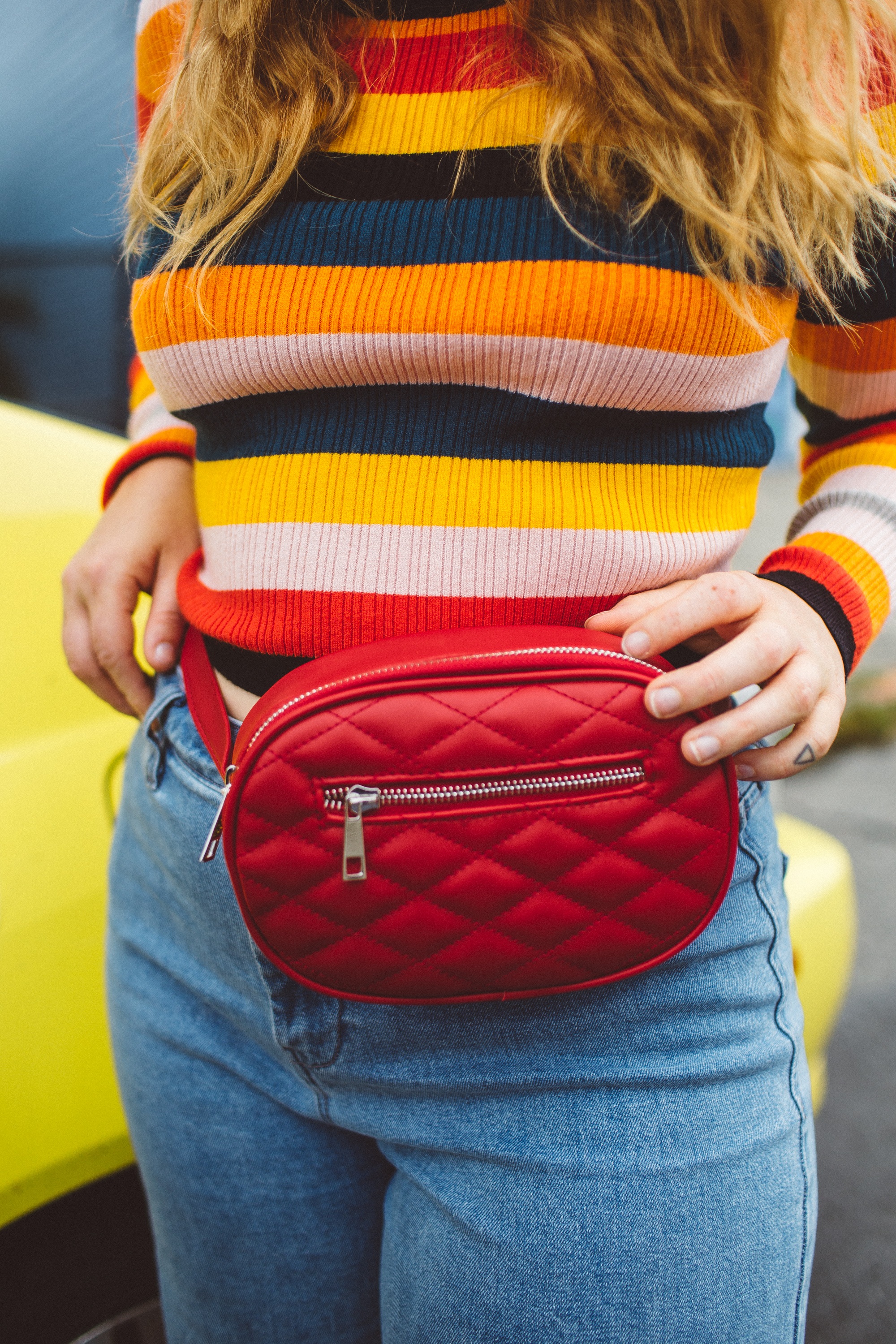 Woman wearing red fanny pack