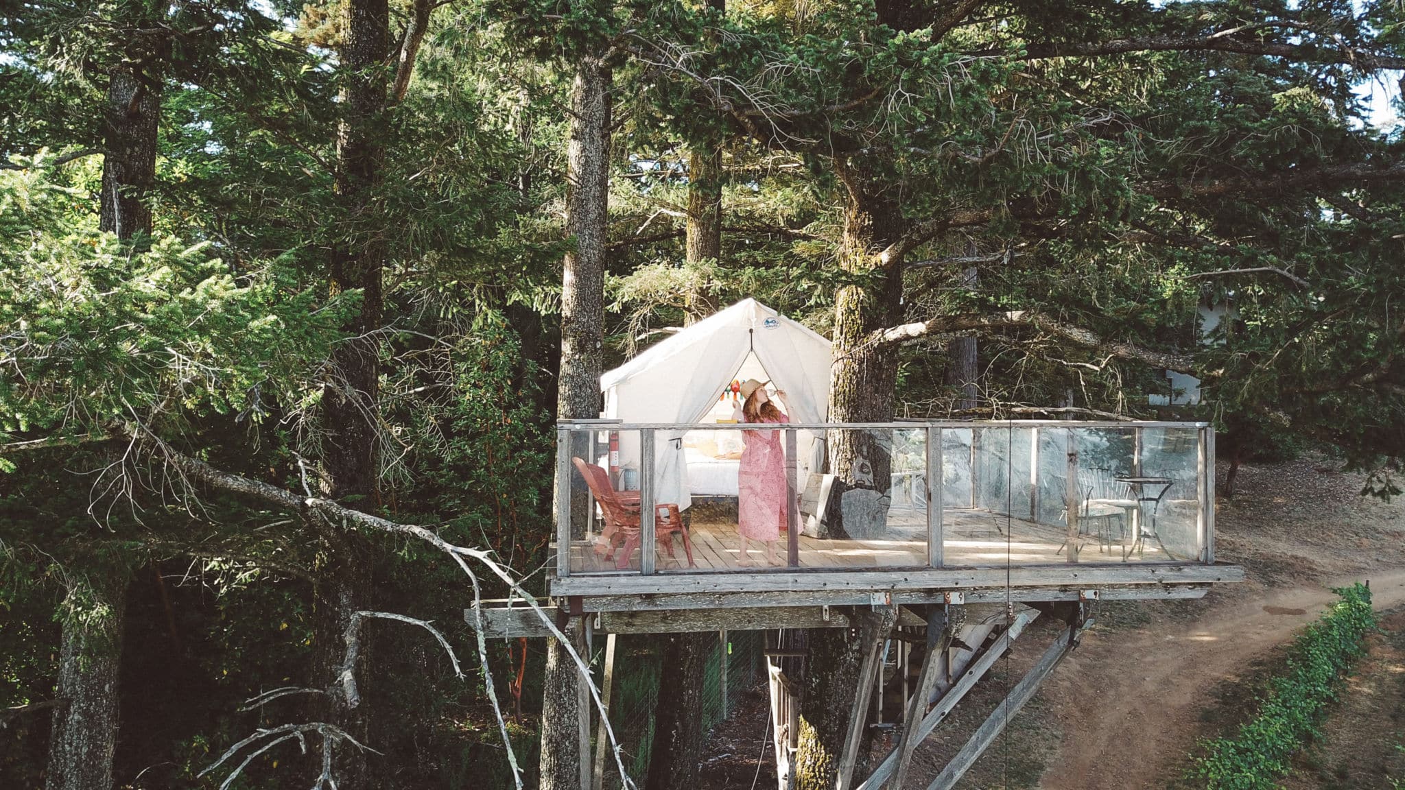 Woman drinking Wine on a treehouse Airbnb
