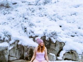 woman in pink swimsuit sitting by hot tub