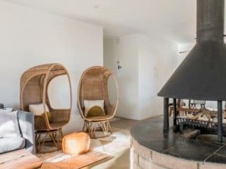 Fun Wicker Chairs and a old style fireplace in this Joshua Tree Airbnb