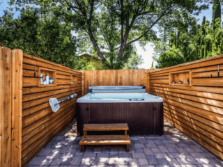 Chic outdoor hot tub with wood panels located in a Sedona Arizona Airbnb